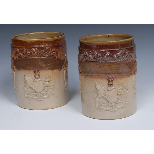 40 - A mid 19th century brown salt glazed stoneware cylindrical pharmaceutical jar, in relief with crest,... 
