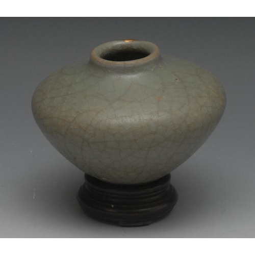 18 - A Chinese celedon globular vase, crackle glaze, 7.5cm high, hardwood stand