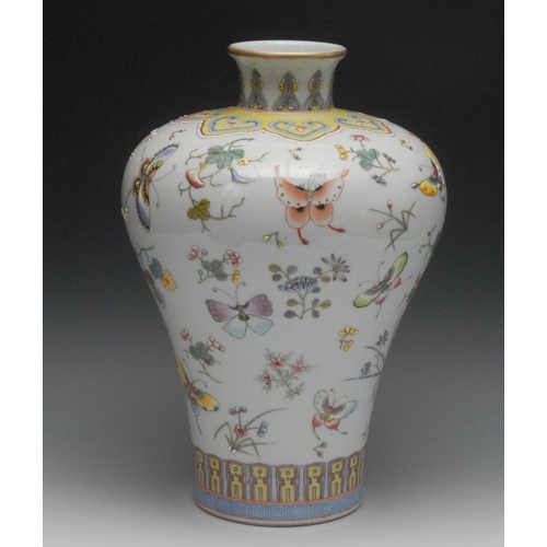 41 - A Chinese porcelain shouldered ovoid vase, brightly painted in raised polychrome enamels with butter... 