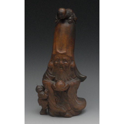 44 - A Chinese terracotta figure, of a bearded deity, possibly Shou, he stands holding a gourd and cover,... 