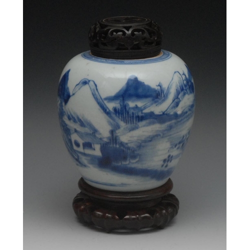 51 - An 18th century Chinese ovoid ginger jar, painted in underglaze blue with mountains and huts, hardwo... 