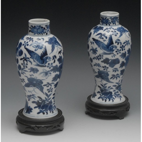 60 - A pair of Chinese baluster vases, decorated in underglaze blue with peonies and birds in flight, 18c... 