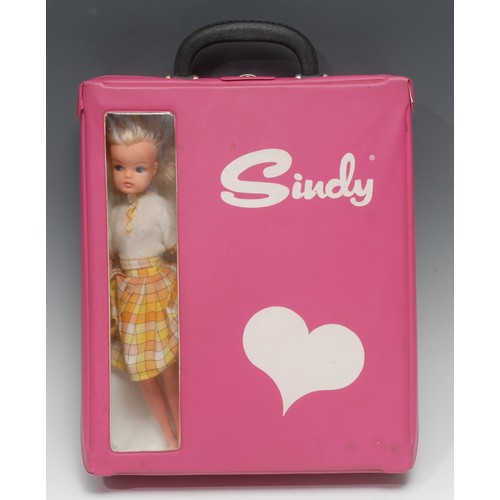 2023 - A vintage 1970's rectangular shaped pink vinyl Sindy carry case with single clothes hanger; a late 1... 