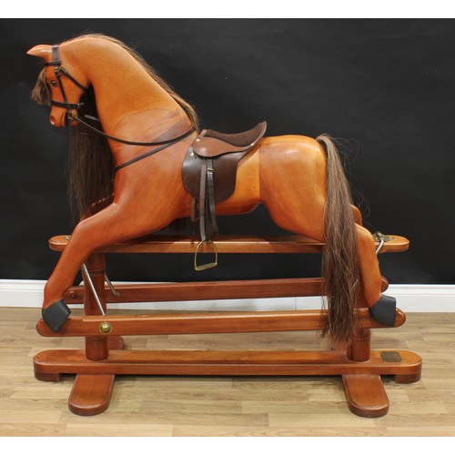 2038 - A 20th century House of Marbles (Devon) carved hardwood rocking horse on safety stand, carved sectio... 