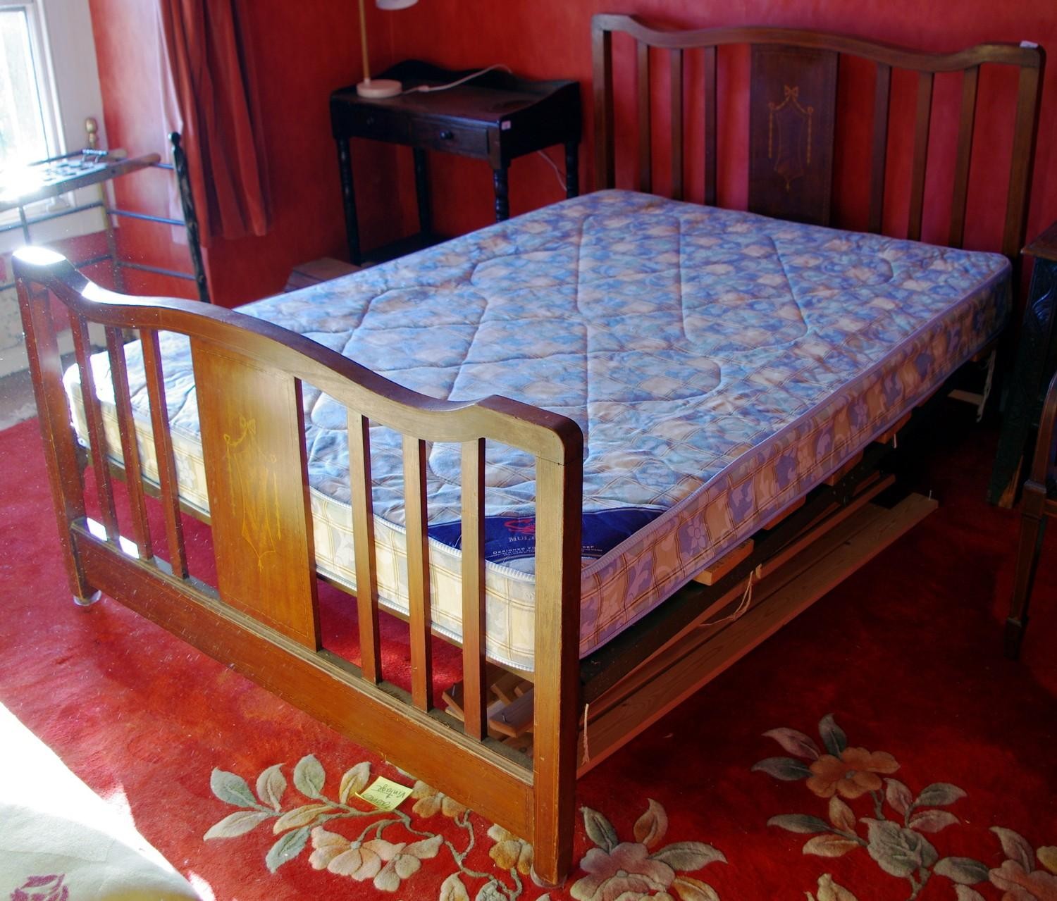 An early 20th century mahogany and boxwood strung double bed head and foot...