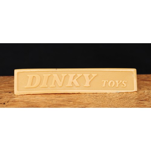 5047 - Advertising - a Dinky Toys triangular shaped point of sale display stand, unpainted, 17cm long