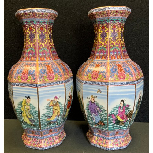 44 - A pair of contemporary Chinese octagonal vases, each side decorated with a figural panel, multi colo... 