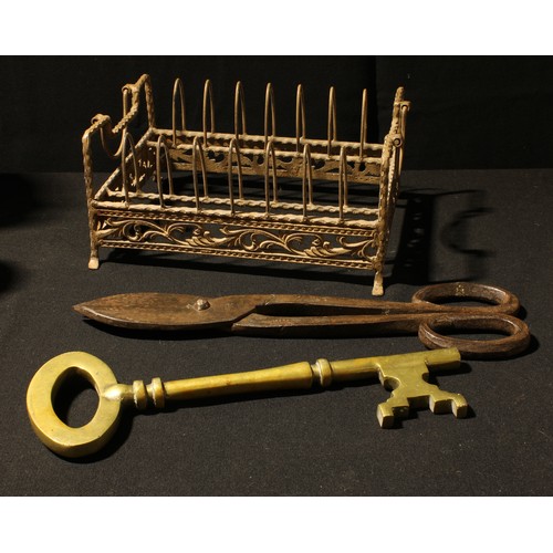 143 - A large pair of blacksmith's shears, 41cm long; a large brass key, 35cm long; a wrought metal rack w... 