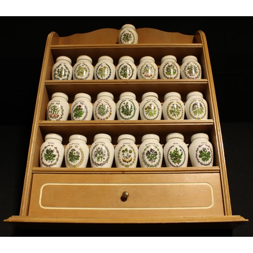 A set of twenty two Franklin Mint spice jars on kitchen rack, designed