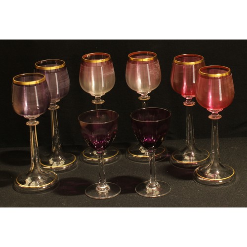 25 - A set of six tulip shaped hock wine glasses, the ribbed bowls in shades of pink and amethyst, slende... 