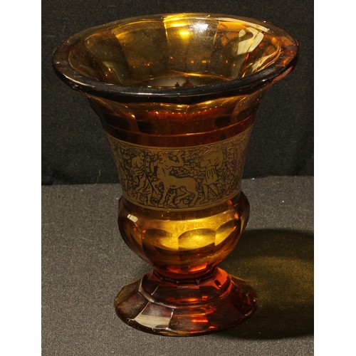 37 - An early 20th century Moser Amber glass thistle shaped vase, gilt band of warriors, 15.5cm high, sig... 