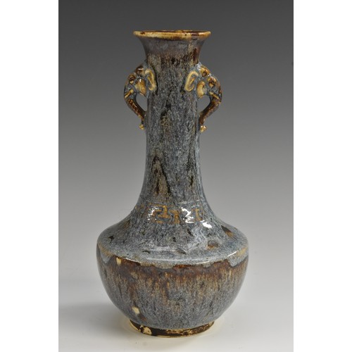 54 - A Chinese Jun ware earthenware bottle vase, glazed in merging mottled tones of blue and purple, with... 