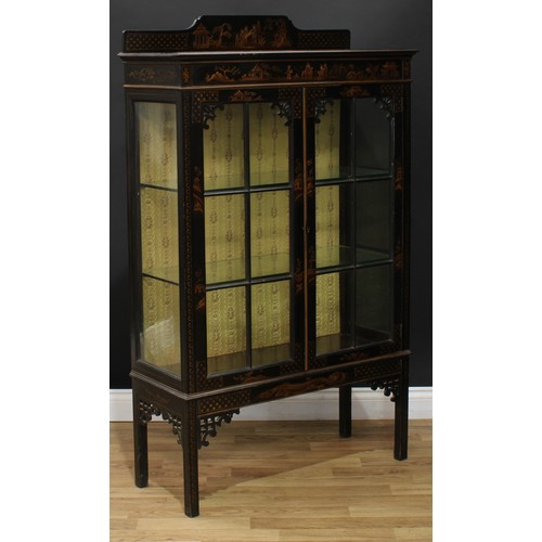 6 - An early 20th century japanned and chinoiserie display cabinet, shaped half gallery above a pair of ... 