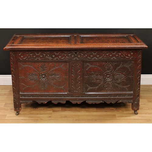 9 - An 18th century oak blanket chest, hinged rectangular top above a blind fretwork frieze carved with ... 