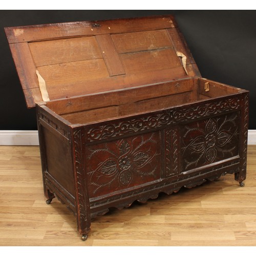 9 - An 18th century oak blanket chest, hinged rectangular top above a blind fretwork frieze carved with ... 