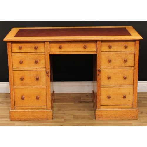 12 - An Arts & Crafts period oak desk, rectangular top with moulded edge and inset writing surface above ... 