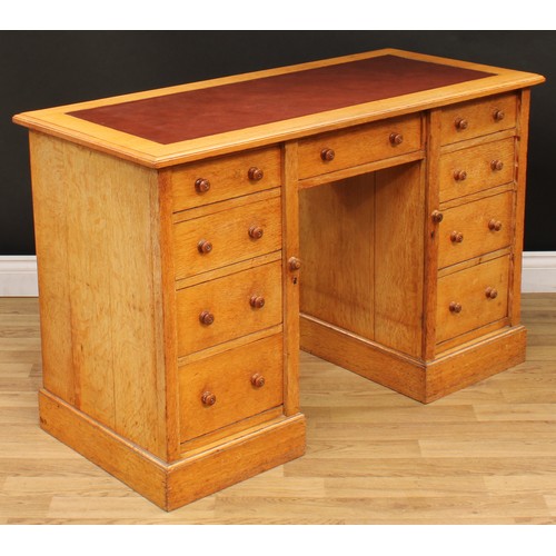 12 - An Arts & Crafts period oak desk, rectangular top with moulded edge and inset writing surface above ... 