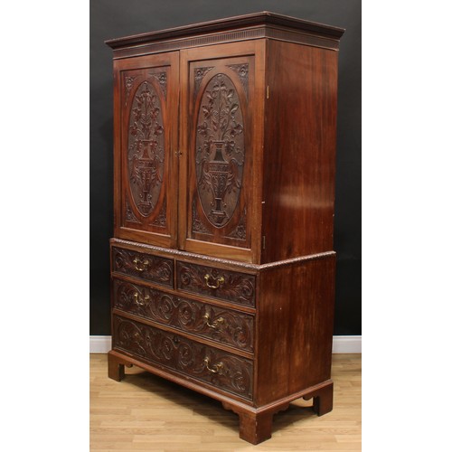 13 - A 19th century mahogany linen press, moulded dentil cornice above a nulled capital and a pair of pan... 