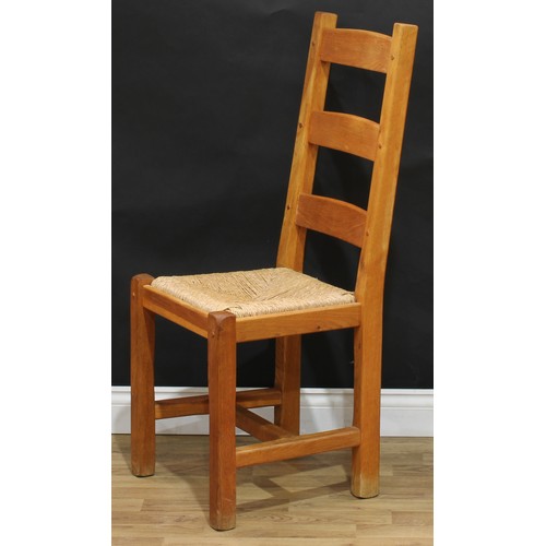 16 - A set of four contemporary oak dining chairs, drop-in rush seats, 107cm high, 47cm wide, the seat 36... 