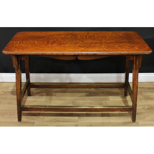 20 - An Arts & Crafts oak serving table or centre table, moulded rounded rectangular top, shaped frieze, ... 