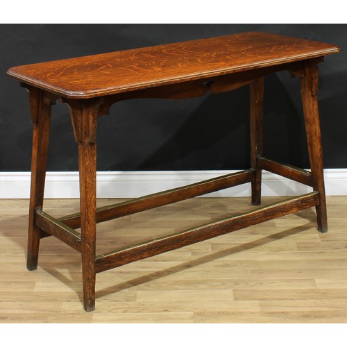 20 - An Arts & Crafts oak serving table or centre table, moulded rounded rectangular top, shaped frieze, ... 