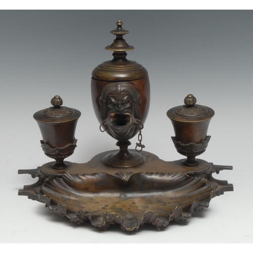 3043 - A 19th century Grand Tour brown patinated bronze ink stand, the central lamp cast with an Egyptian m... 