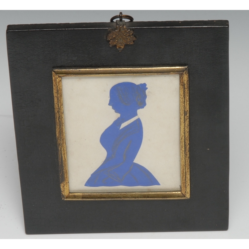 3024 - A 19th century cut paper silhouette, of a young lady, three-quarter length in profile facing to dext... 