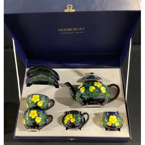 28 - A contemporary Moorcroft tea for two, Buttercup, tube lined with bright flowerheads, boxed