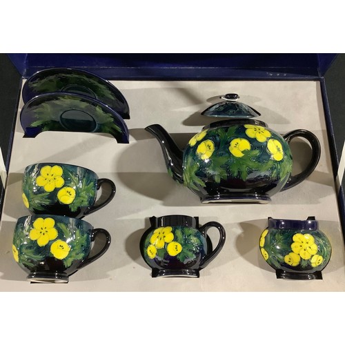 28 - A contemporary Moorcroft tea for two, Buttercup, tube lined with bright flowerheads, boxed