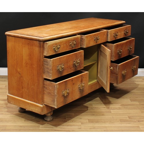 3 - A 19th century farmhouse pine low dresser, rectangular top above and arrangement of short drawers an... 