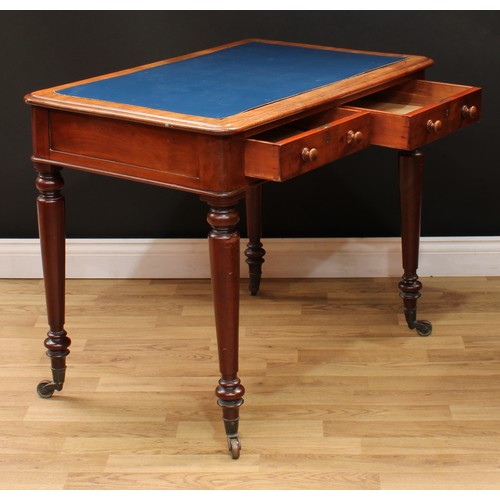 5 - A Victorian mahogany writing table, rounded rectangular top above a pair of frieze drawers, turned l... 