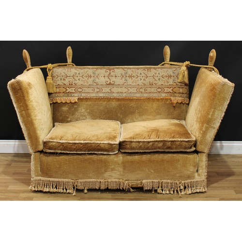 10 - An early 20th century Knole type sofa, rectangular back applied in the carpet suite manner, drop arm... 