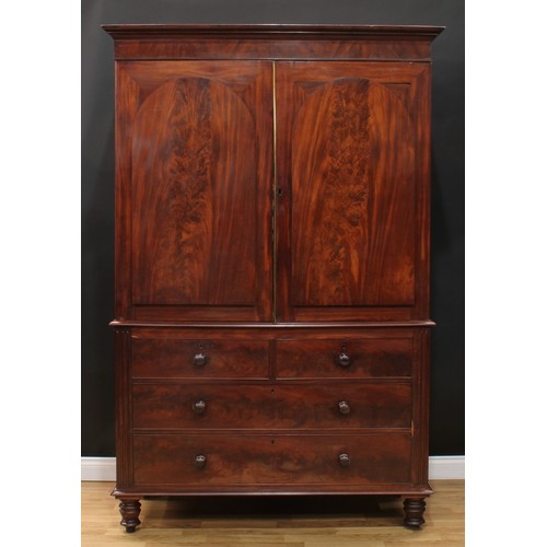 15 - A 19th century mahogany linen press, moulded cornice above a pair of doors enclosing five sliding tr... 