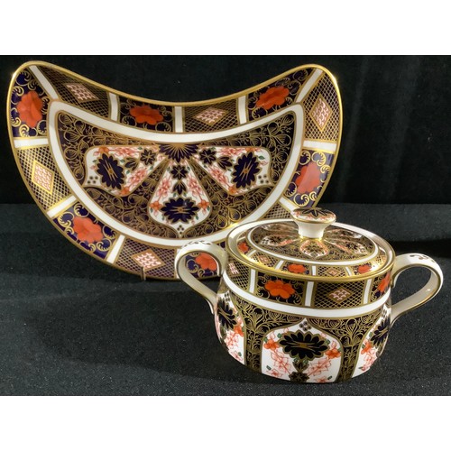 9 - A Royal Crown Derby Imari 1128 pattern sucrier and cover, an 1128 crescent shaped salad dish, second... 