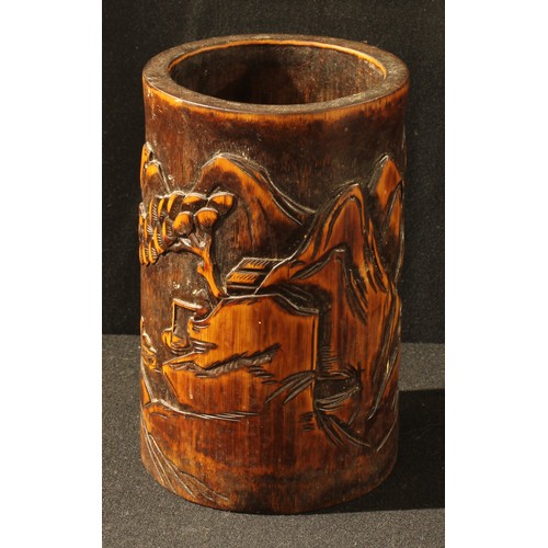 22 - A Chinese bamboo bitong brush pot, carved in relief with a monumental landscape, 17.5cm high
