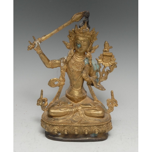 35 - Chinese School, a gilt bronze, Manjushri Tara, seated in meditation with sword, lotus base, sealed, ... 