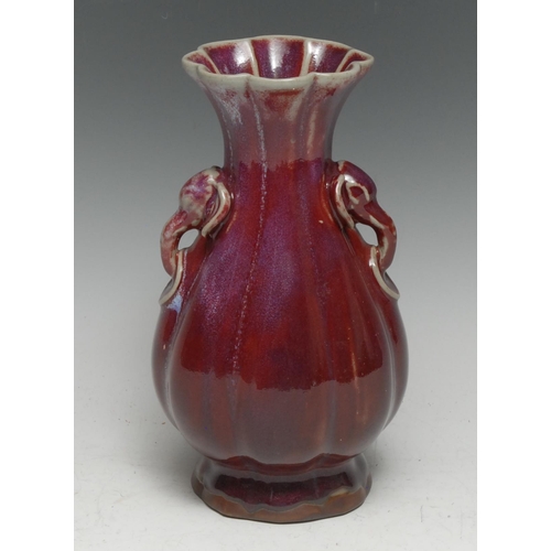 51 - A Chinese monochrome fluted baluster vase, glazed in tones of mottled puce, moulded elephant mask ha... 