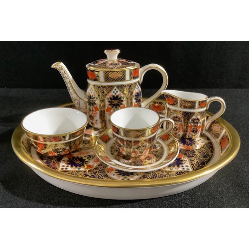 56 - A Royal Crown Derby 1128 Imari pattern miniature tea set, comprising teapot, cream jug, sugar bowl, ... 