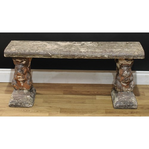 42 - A reconstituted stone garden bench, the end supports cast as squirrels, 44cm high, 101cm wide, 32cm ... 