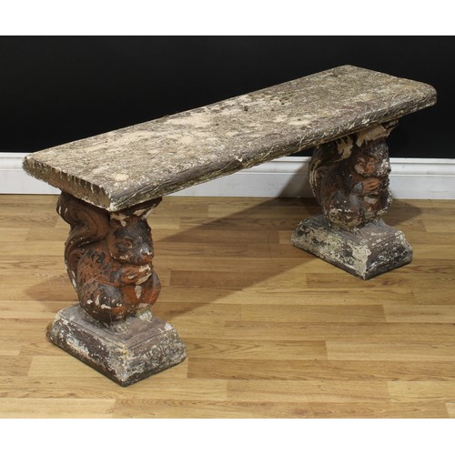 42 - A reconstituted stone garden bench, the end supports cast as squirrels, 44cm high, 101cm wide, 32cm ... 