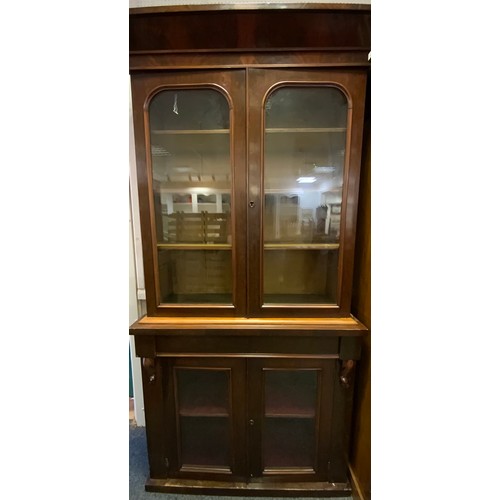 4 - A Victorian mahogany bookcase, outswept cornice about a pair of glazed panel doors enclosing adjusta... 
