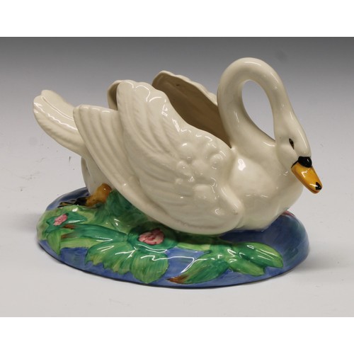 4 - A Clarice Cliff posy holder modelled as a swan swimming on an oval lily pad pond, printed mark, 26cm... 