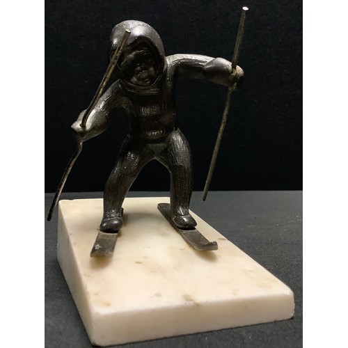 18 - Continental School (early 20th century), a dark patinated bronze, of a child skiing, marble faux ski... 