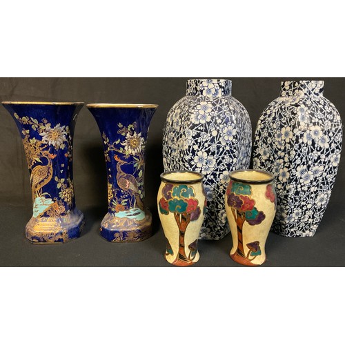 25 - A pair of Carlton Ware Kang He rockery and pheasant lustre vases, 19.5cm high; a pair of Royal Doult... 