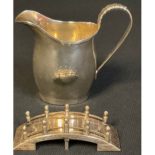 53 - A George V silver helmet shaped cream jug, Nathan & Hayes, Chester 1914; an Oriental silver novelty ... 
