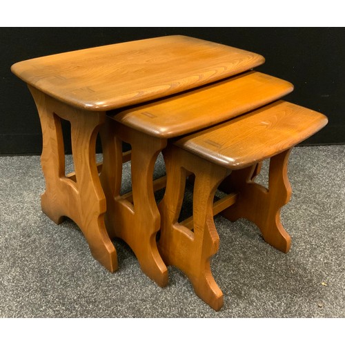 6 - An Ercol elm nest of three occasional tables, 32cm high, 53cm wide.