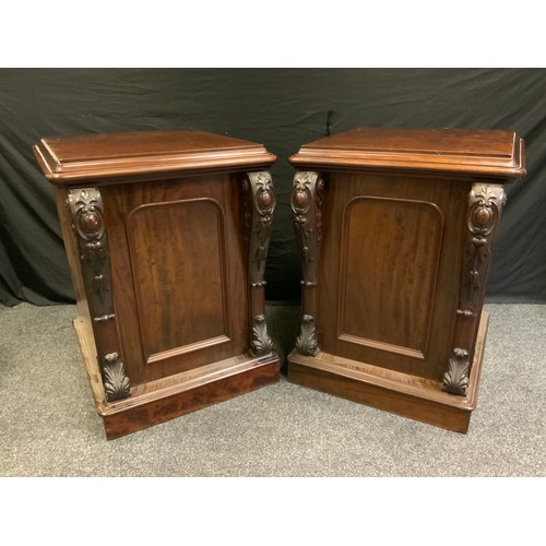 7 - A pair of Victorian mahogany side cupboards, moulded rounded rectangular top above a panelled cupboa... 