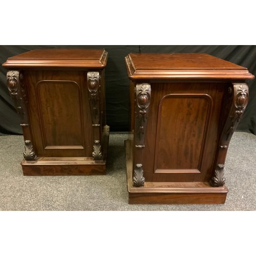 7 - A pair of Victorian mahogany side cupboards, moulded rounded rectangular top above a panelled cupboa... 