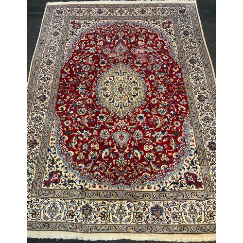 14 - A fine Persian hand made Nain carpet, in tones of red, blue, coffee and cream, 390cm x 290cm