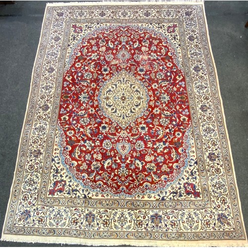 14 - A fine Persian hand made Nain carpet, in tones of red, blue, coffee and cream, 390cm x 290cm